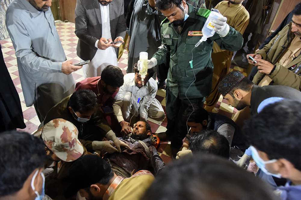 Paramedics treat an injured passenger at the Mach railway station, which has been turned into a makeshift hospital, after Pakistani security forces freed nearly 80 passengers following a security operation against armed militants who ambushed the train in the remote mountainous area, in Mach, southwestern Balochistan province on March 11, 2025. (AFP)