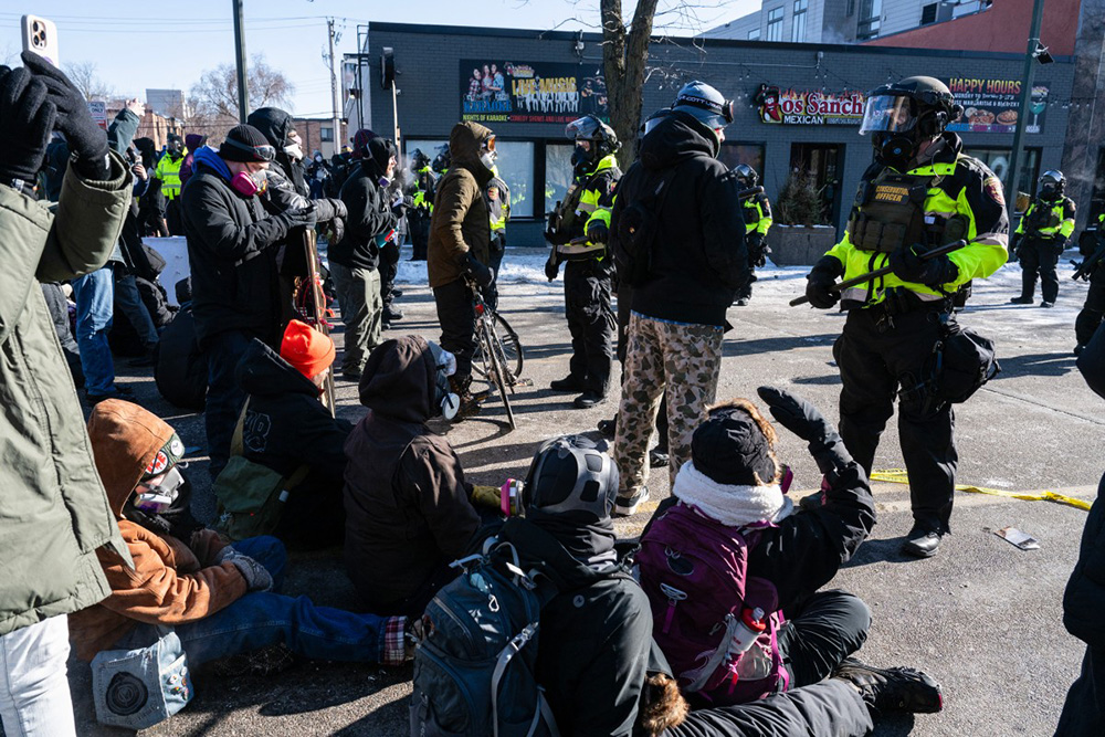 Minnesota Department of Natural Resources Conservation Officers stand guard as demonstrators gather near the site of where state and local authorities say a man was shot and killed by federal agents earlier in the morning in Minneapolis, Minnesota, on January 24, 2026. (Photo by ROBERTO SCHMIDT / AFP)