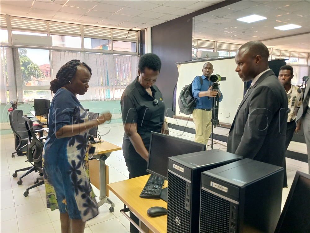 Kagina (center) examines some of the latest equipment.