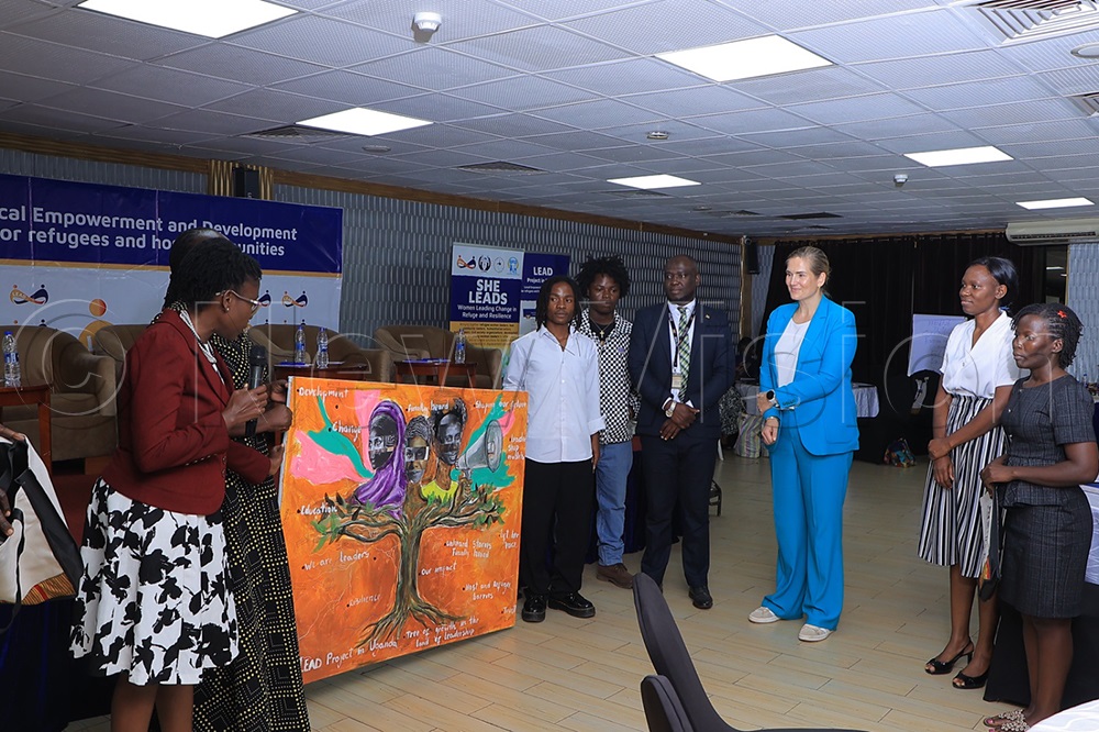 Quispel listens as refugee Congolese boys explain an art piece depicting women in leadership. (Credit: Prossy Nandudu)