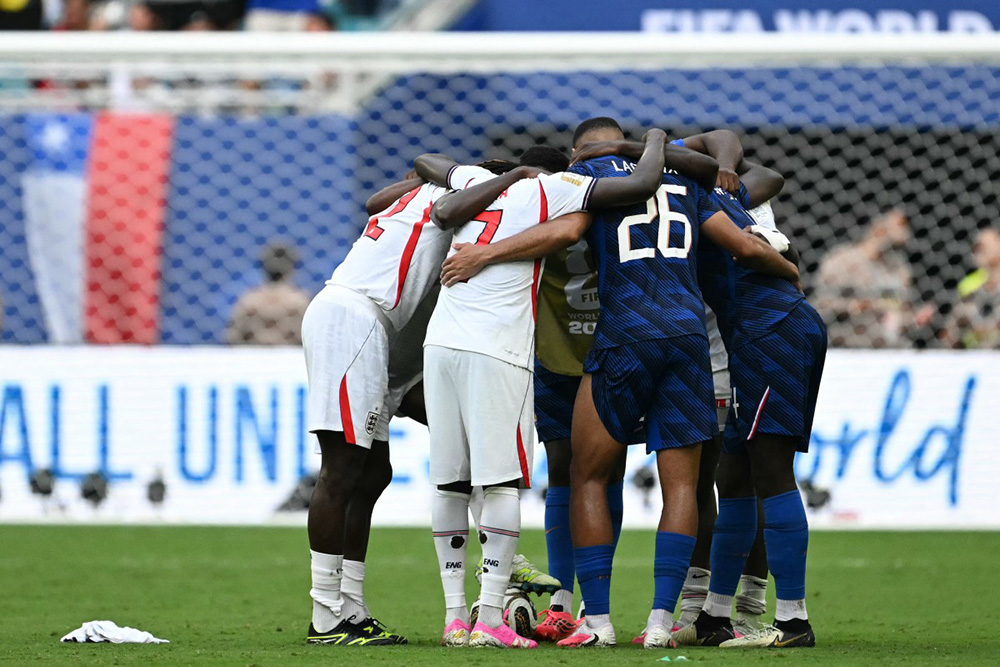France and England players gather in a group at the end of the 2026 World Cup football tournament third-place match between France and England at the Miami Stadium in Miami on July 18, 2026. (Photo by CHANDAN KHANNA / AFP)