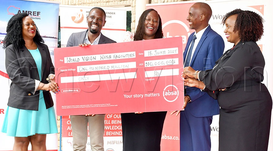 World Vision Marketing and Communications director Connie Nankya (left), Marketing Officer Willy Mwesigwa (2nd left) and World Vision National Director Jeremiah Nyangah (2nd right) receive a sh100m cheque from Absa Bank's Hellen Basuuta and Irene Mutyaba (right) at Absa Bank's head office. PHOTO: Michael Nsubuga