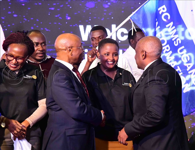 Emmanuel Katongole (R), the Rotary International director, and Prof. Augustus Nuwagaba, the Bank of Uganda deputy governor, speaking to Sheila Nduhukire, the incoming president of the Rotary Club of NMS Uganda.