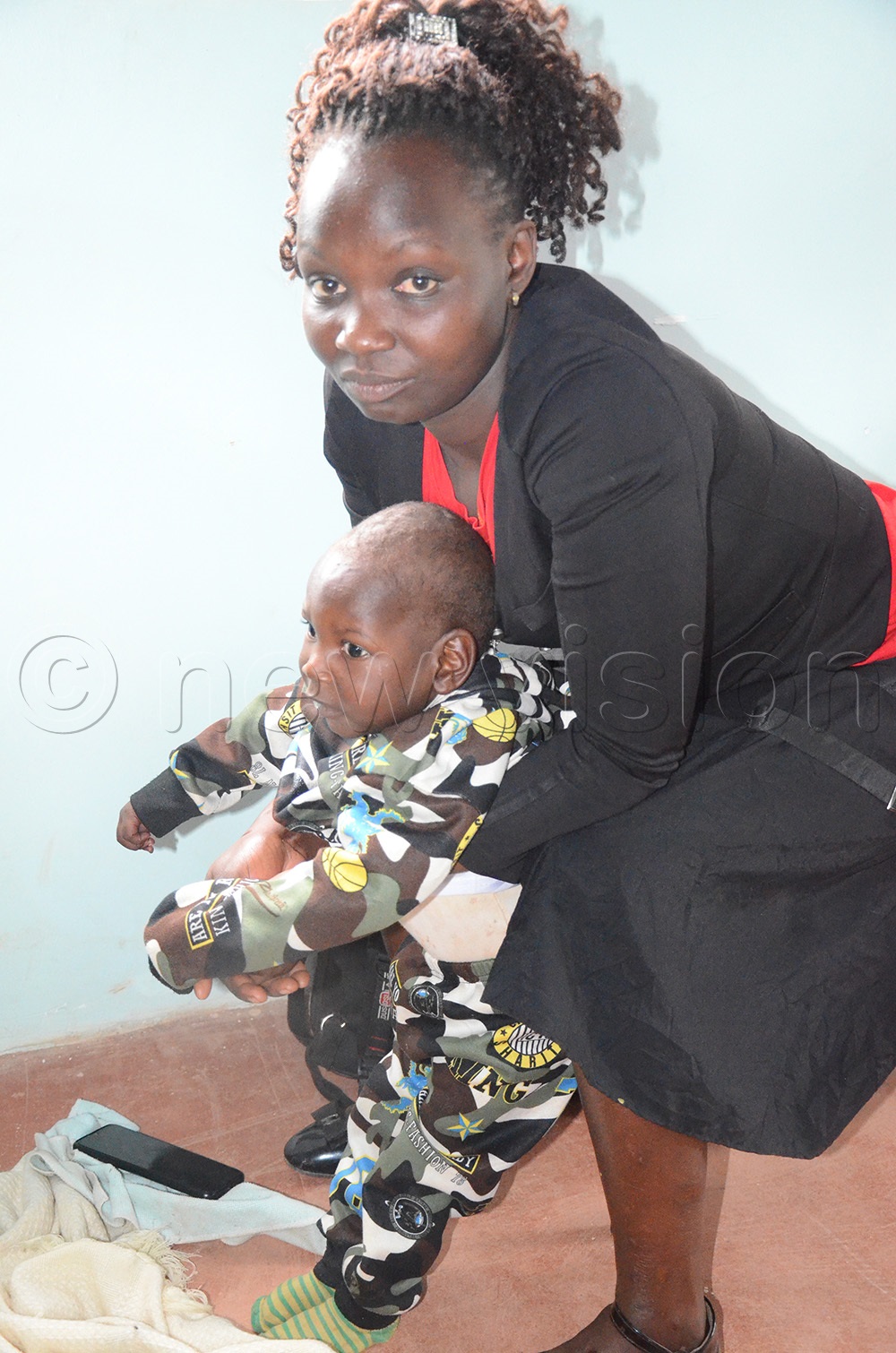 19-year-old Evelyne Mukite with her child, Brighton Bwayo, who suffers from a nuerologicl condition. (Photo by Sam Wakhakha)