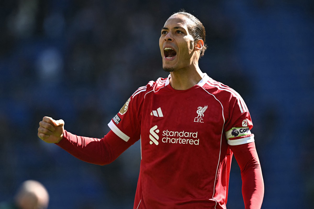 Liverpool's Dutch defender #04 Virgil van Dijk celebrates on the pitch after the English Premier League football match between Everton and Liverpool at Hill Dickinson Stadium in Liverpool, north west England on April 19, 2026. Liverpool won the game 2-1. 
