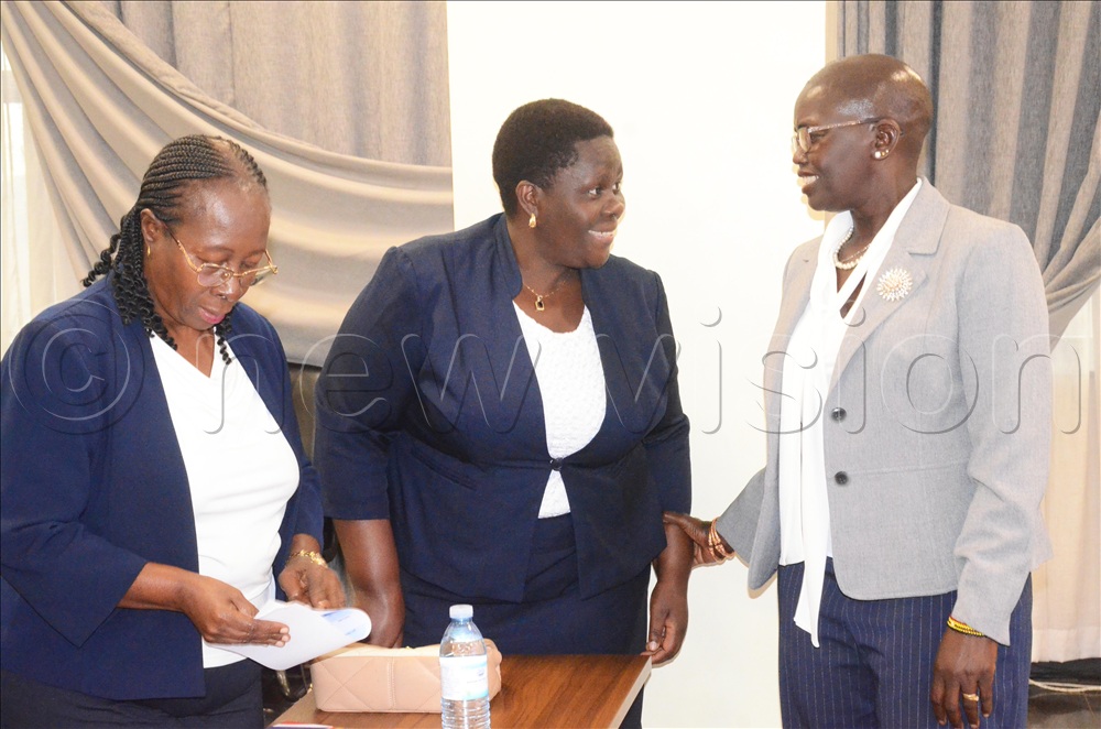 Principal Judge Justice Jane Frances interacting with a judicial officer while attending the launch of the succession resource book in Uganda. 