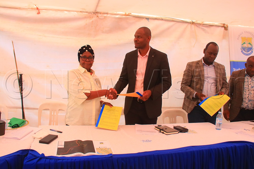 Kabale University Vice Chancellor Prof. Joy Kwesiga (Left) shaking hands with National Forestry Authority led by Executive Director Stuart Maniraguha after signing the MoU. (Credit: Nelson Ahimbisibwe)