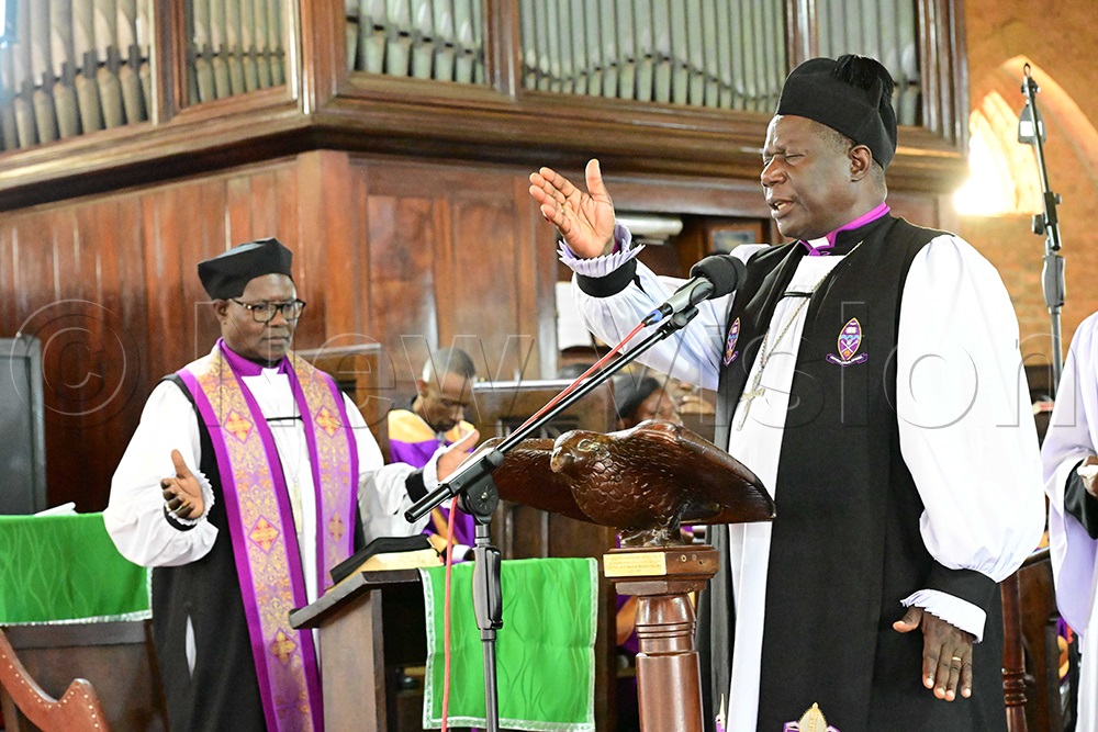 Bishop Moses Banja of Namirembe (right) prays during the funeral service for the late former Bishop of West Buganda Diocese, Dr Christopher Ssenyonjo, at Namirembe Cathedral on July 24, 2026. Also pictured is former Bishop of West Buganda, Katumba Tamale (left). (Credit: Eddie Ssejjoba)