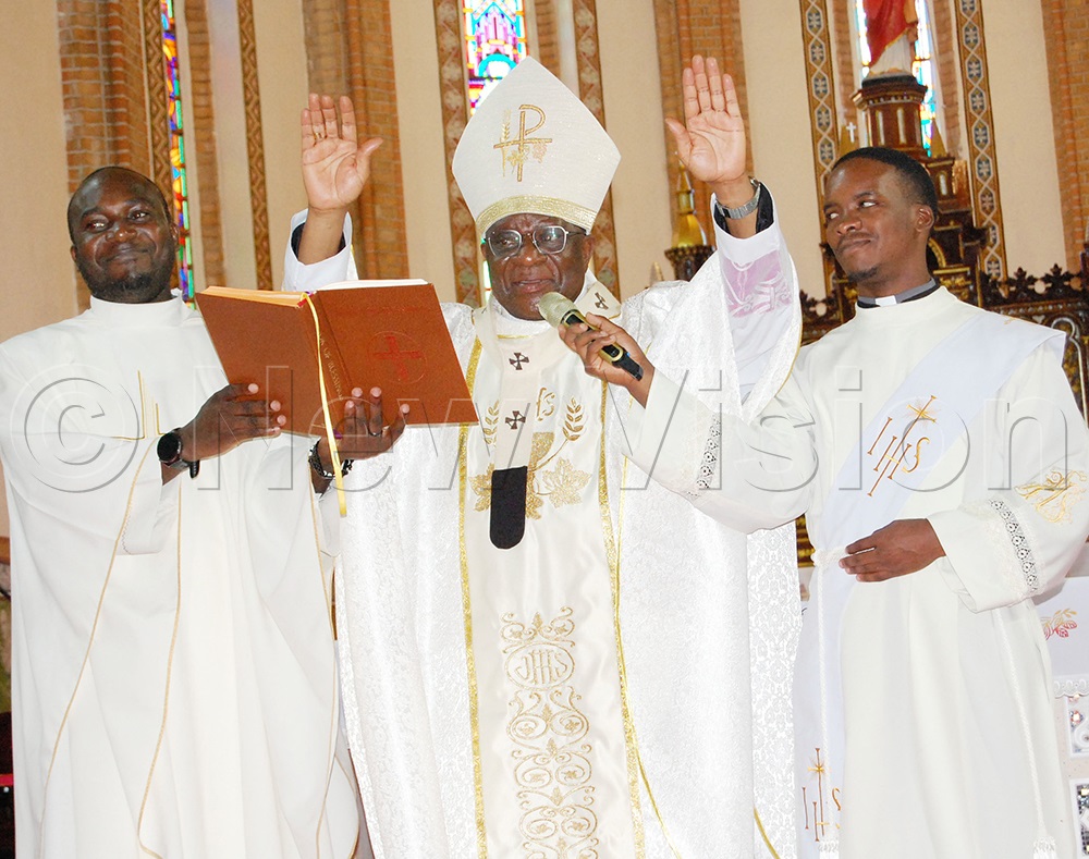 Archbishop Paul Ssemogerere (centre) praying a blessing for the children. (Photo by Mathias Mazinga)