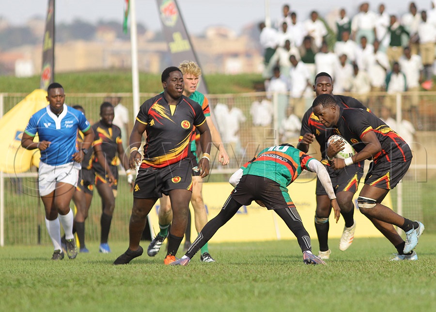 Uganda's Prince Kakaire takes on Zambian opponents with the ball during the U20 Barthes Cup at Wankulukuku. PHOTO: Johnson Were