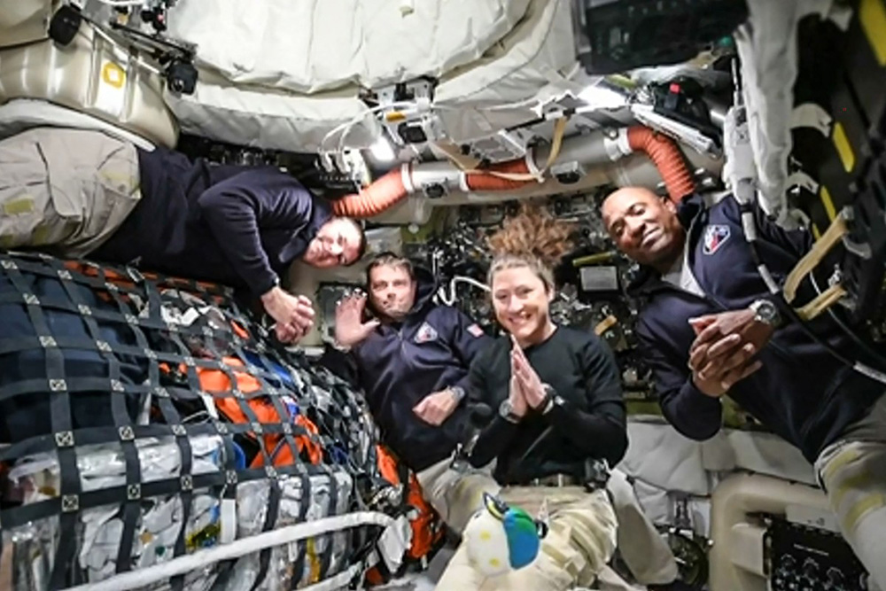 This screen grab from NASA's feed released on April 3, 2026, shows the four Artemis II crew members (L-R) Canadian Space Agency (CSA) astronaut Jeremy Hansen, Artemis II mission specialist, NASA astronauts Reid Wiseman, Artemis II commander, Christina Koch, Artemis II mission specialist and Victor Glover, Artemis II pilot as they head to orbit the Moon for the first time in more than half a century. (Photo by Handout / NASA TV / AFP)