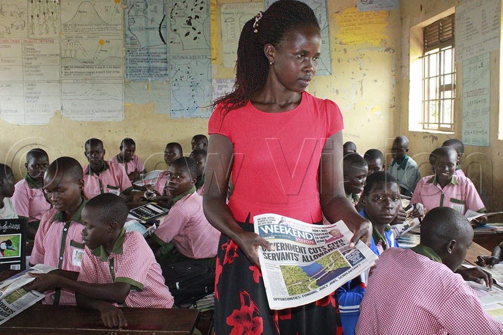 Scovia Akwero distributes newspapers to ensure they are put to good use. (Photo by Ritah Mukasa)