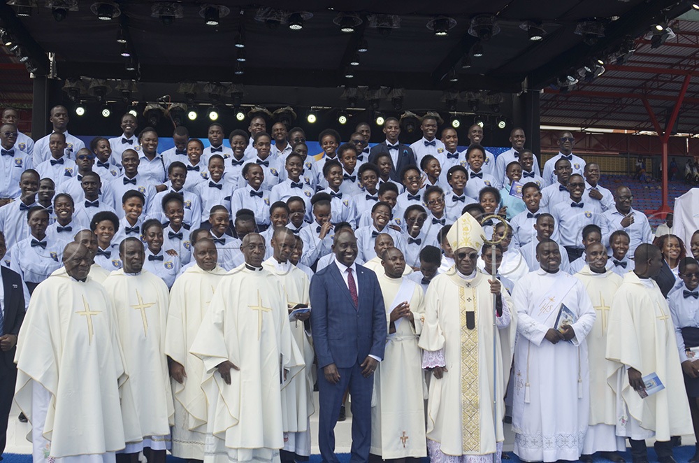 The Archbishop of Kampala, Paul Ssemogerere, poses for a photo with the Director of St Mary’s SS Kitende (SMASK), Dr Lawrence Mulindwa, choir members and other priests after the Holy Mass kicked off celebrations marking 25 years of academic and spiritual excellence of St Mary’s Secondary School Kitende (SMASK). (Photo by Juliet Anna Lukwago)