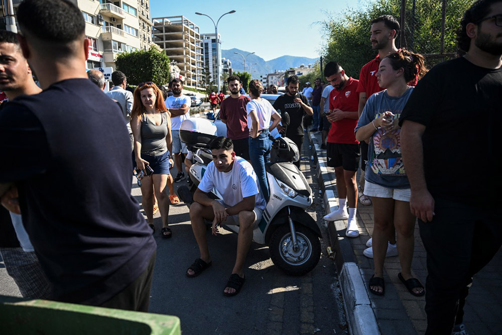 People await news of their loved ones outside the port in Kyrenia, in the self-proclaimed Turkish Republic of Northern Cyprus (TRNC), recognised only by Turkey, on August 30, 2026, after a ferry capsized off the coast. (Credit: AFP)