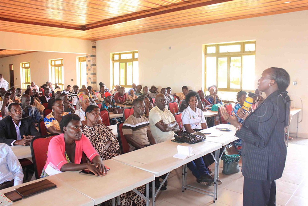 Patricia Ahuura Baseka, the Legal Officer for Equal Opportunities Commission, addressing the residents of Buvuma district on Friday. (Photo by Henry Nsubuga)