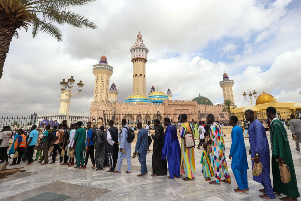This year marks the 131st observance of the pilgrimage. Followers honor the occasion by visiting the Great Mosque of Touba and the tomb of Sheikh Ahmadou Bamba to perform prayers and pay their respects. (Photo by CEM OZDEL / Anadolu via AFP)