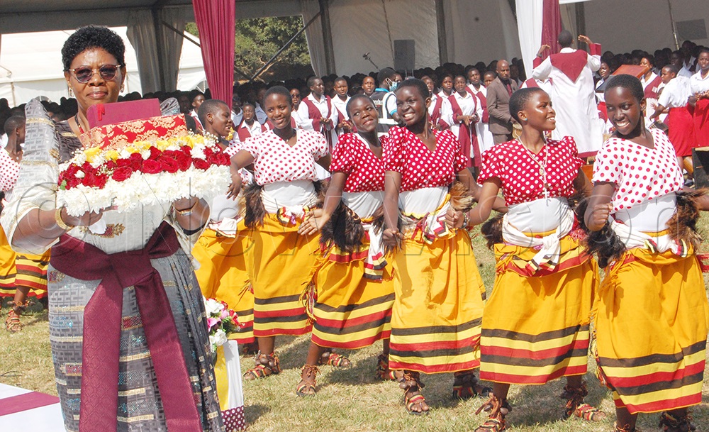 TRICONA students throw a liturgical dance as their headteacher, Immaculate Lwanga moves in procession with the Holy Book during mass. (Photo by Mathias Mazinga)