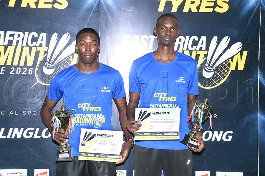 Seroma Christian School’s Eric Ofuyuru (left) poses with Kibuli Secondary School’s Malik Juma Ahmed who he beat 2-1 to win the boys’ U-19 title. Photo by Michael Nsubuga