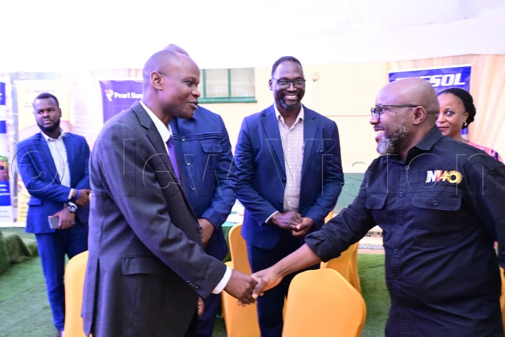 Vision Group CEO, Don Wanyama, greeting Julius Akais, supervisor agribusiness and partnerships at Pearl Bank.
