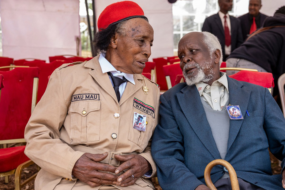 Mau Mau veterans General Njoronge Kinuthia (R) and  Wambui Gichakuri (L) talk to each other during the burial of one Kenya's last Mau Mau resistance fighter, Christopher Njora Muronyo, known as "General Kiambati", in Nyandarua County on February 14, 2026. (Photo by SIMON MAINA / AFP)