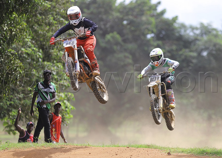 Jonathan Katende (19) battles Ethan Musede during the national Motocross Championship in Garuga. Photo by Johnson Were