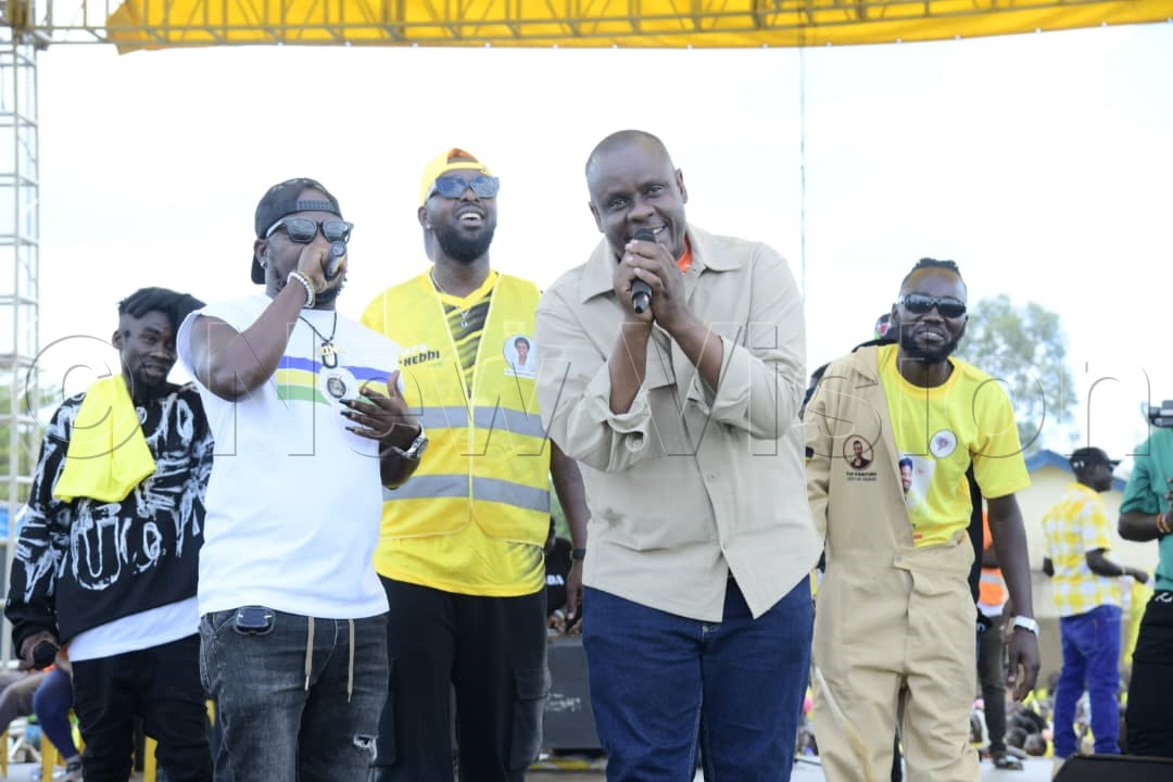 Hon. Balaam Barugahara Ateenyi, State Minister for Youths and Children Affairs, on stage with Eddie Kenzo and other artistes at the rally.