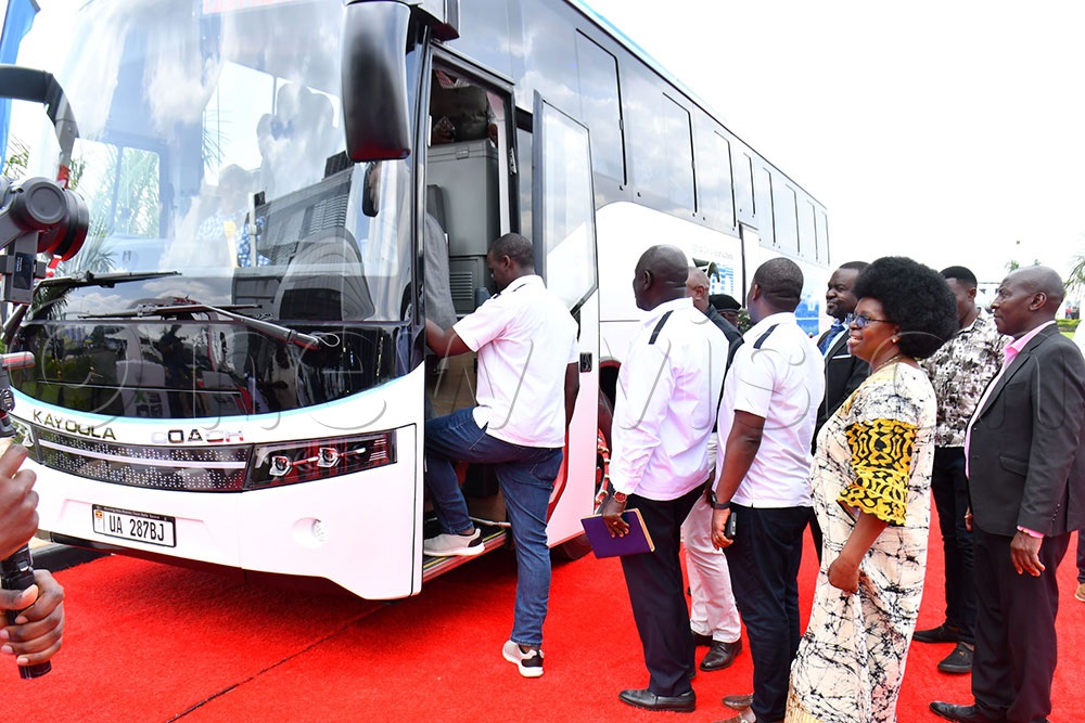 The Minister of Science, Technology and Innovation Monica Musenero (2nd right) and other guests prepare to enter one of the premium electric coaches for a test drive which was handed over to UCAA at Kiira Motors Corporation plant at Mutai village in Jinja district on Friday. (Photo by Donald Kiirya)