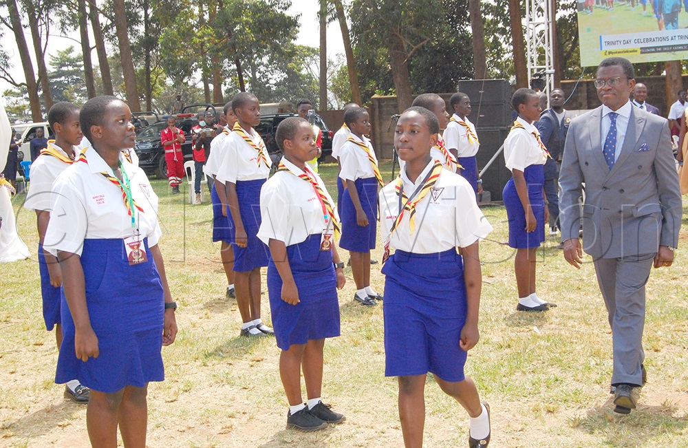 Katikkiro Charles Peter Mayega inspecting the parade of the girl-guides of TRICONA. (Photo by Mathias Mazinga)