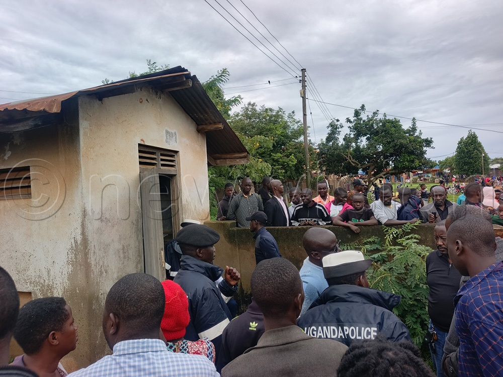 Traffic Police officers and locals at the Buwenge Health Centre IV morgue where Kalanga's body was taken for postmortem. (Photo by Jackie Nambogga)
