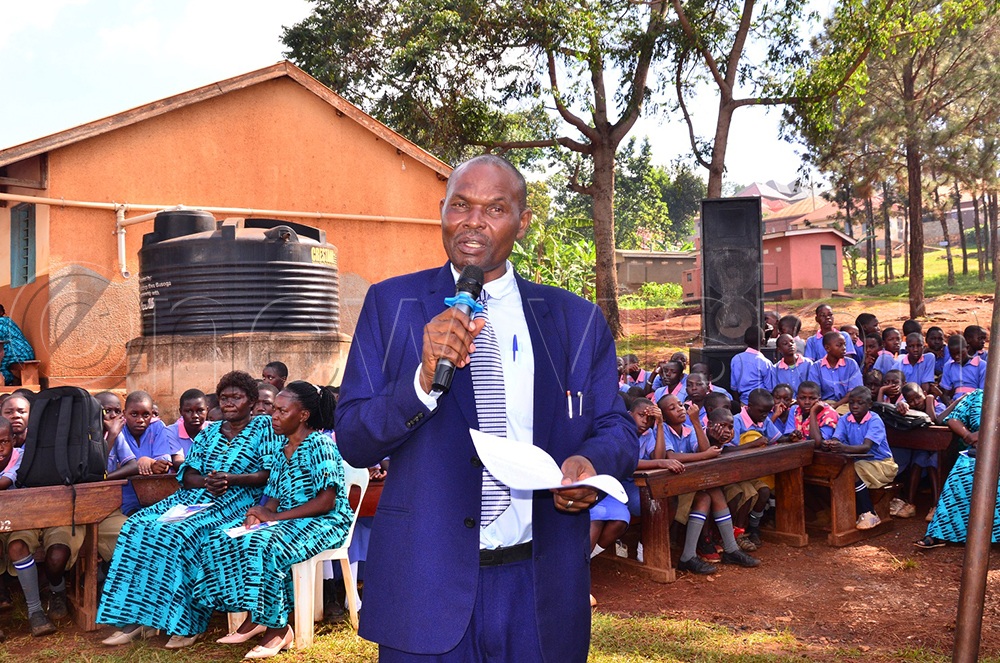 Nathan Wagabaza, the head teacher of the school, speaks during the function, noting that the newly constructed staff units are the first to be built at the school in its 68-year history. (Credit: Jackie Nambogga)