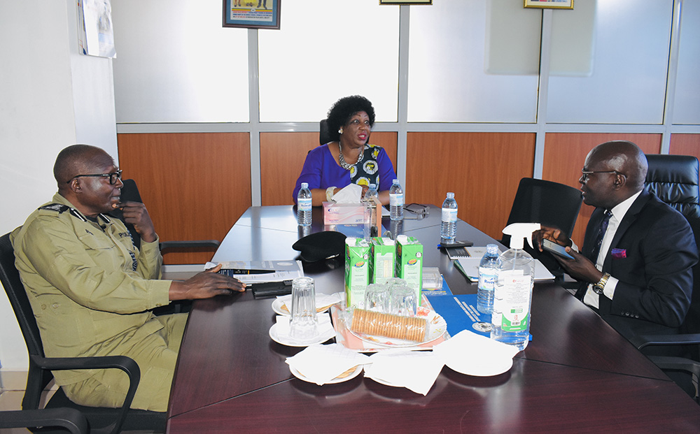 In the centre is the Chairperson of the Uganda Human Rights Commission (UHRC) Mariam Wangadya, discussing with EC Chairperson Justice Simon Byabakama (R) and IGP Abas Byakagaba (L). (Courtesy photo)