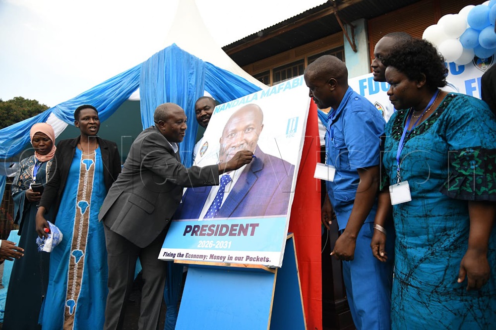 Nathan Nandala Mafabi signing on his official campaign portrait. (Credit: Maria Wamala)