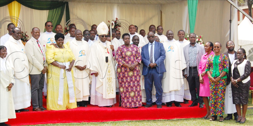 Catholic clerics led by Archbishop Paul Ssemogerere (holding a crosier) share a photo-moment with Vice-President Jessica Alupo (on the archbishop's immediate left), Prof. Barnabas Nawangwe (fourth-left) and other dignitaries after the thanksgiving mass for the celebration of the 85th anniversary of St. Augustine Chapel, Makerere University on Sunday, April 12, 2026. 