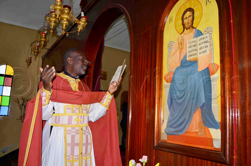 An Orthodox priest, Fr Isabirye reciting a prayer during Metropolitan Lwanga's memorial mass at Namungoona Orthodox Cathedral on Monday. (Photo by Mathias Mazinga)