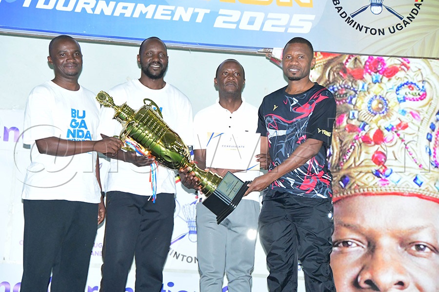 Ndejje University team wins the 32nd Kabaka Coronation Badminton tournament on August 10, 2025. The Minister of Sports in the Buganda government, Robert Sserwanga (second right), hands over the trophy. Photo: Silvano Kibuuka