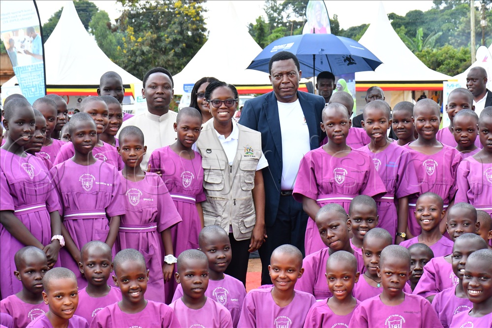 Dr. Charles Olaro (middle), the Director General of Health Services in the Ministry of Health in a group photograph with pupils of Buckley High School while at celebrations to mark World Malaria Day at Bulamaji sub-county headquarter ground in Iganga district.  
