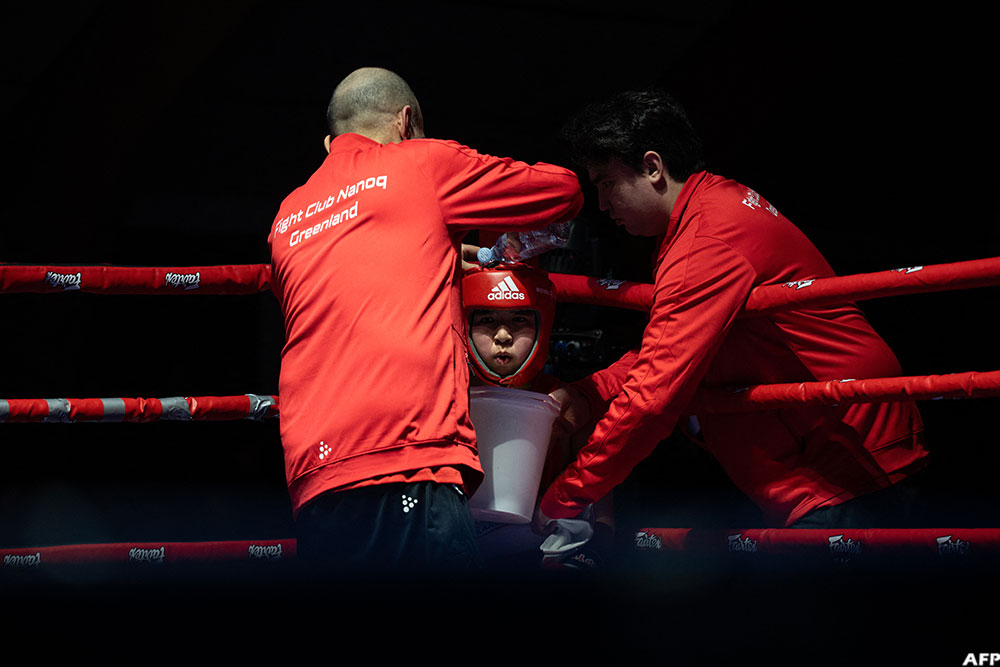 A boy from the club has water poured over his head during a break in a boxing match in Nuuk, Greenland, on February 28, 2026