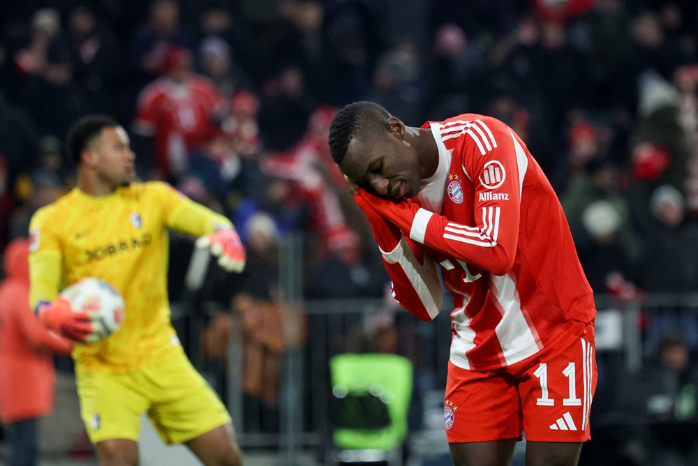 Bayern Munich's Senegalese forward #11 Nicolas Jackson celebrates scoring his team's fifth goal during the German first division Bundesliga football match between FC Bayern Munich and SC Freiburg in Munich, southern Germany on November 22, 2025.