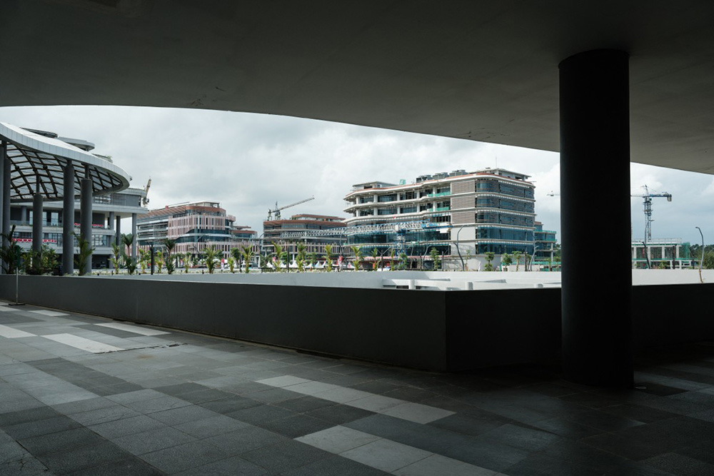 This picture taken on August 15, 2025, shows new buildings in Ibu Kota Nusantara (IKN), the planned new capital of Indonesia, East Kalimantan. A year after it was inaugurated, Indonesia's would-be new capital Nusantara attracts tourists and construction workers, but most of its architecturally arresting presidential palace and freshly built avenues sit silent. (Photo by YASUYOSHI CHIBA / AFP)