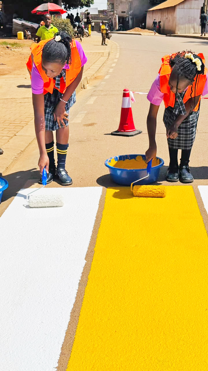 Learners join Rotary Club of Kanyanya in painting and installing zebra crossings.