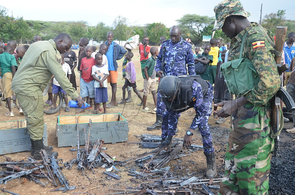 Security officers arranging gun parts that were not burnt at the end of the exercise. (Photo by Olandason Wanyama)
