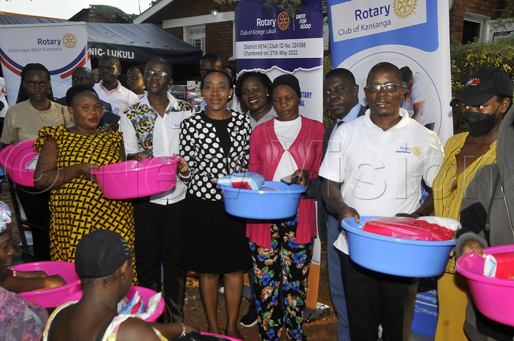 Rotary District Governor 9214, Christine Kyeyune, Rotary (centre in black and white dress), handing over Mama kits to mothers at Hope clinic during the handover at the clinic rehabilitated by the Rotary club of Kansanga, September 16, 2025. (Photo by Wilfred Sanya)