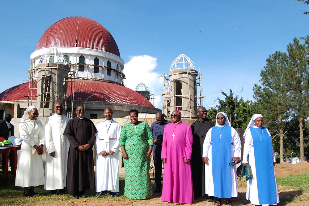 Vice-President Jessica Alupo (fifth-left), Archbishop Paul Ssemogerere (fourth-right) and other Catholic religious men and women share a photo moment at the  proposed Mount Sion Prayer Centre Church that is under construction. (Photo by Mathias Mazinga)