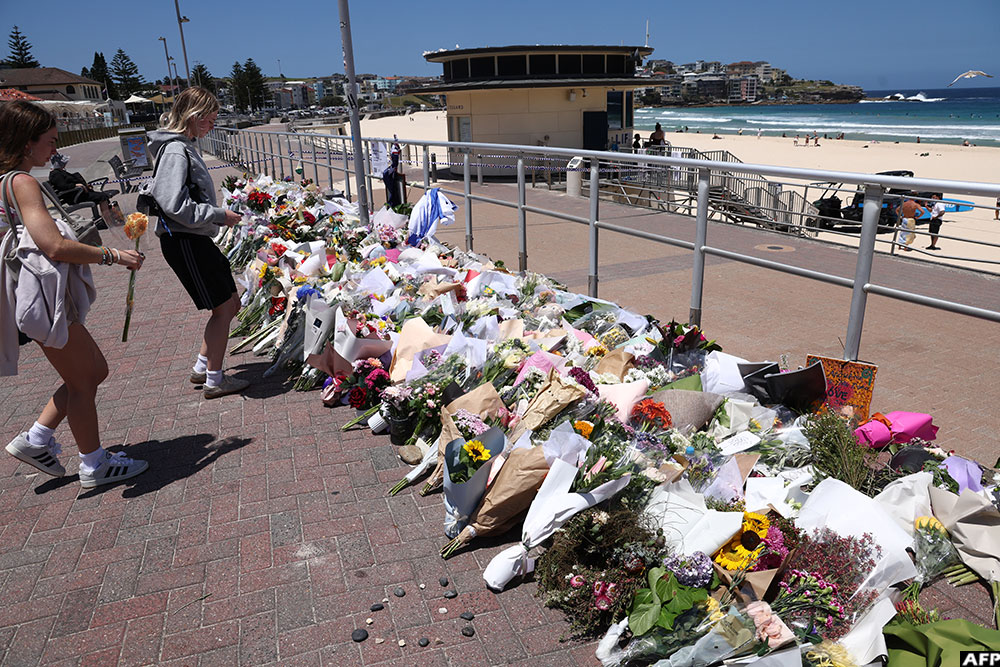 People leave floral tributes at the promenade of Bondi Beach in Sydney.