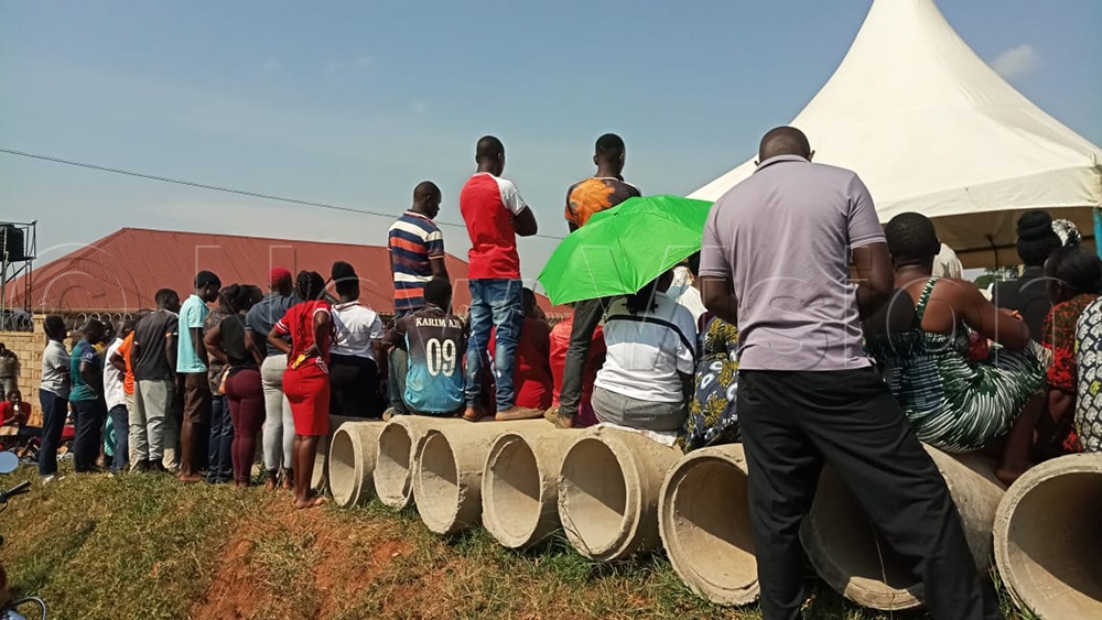 Residents of Nakwero A Cell, Kimwanyi Ward, in Kira Municipality, Wakiso District, stand on culverts as they wait for their names to be read during the LC1 Chairperson elections. (Photo by Francis Emorut)