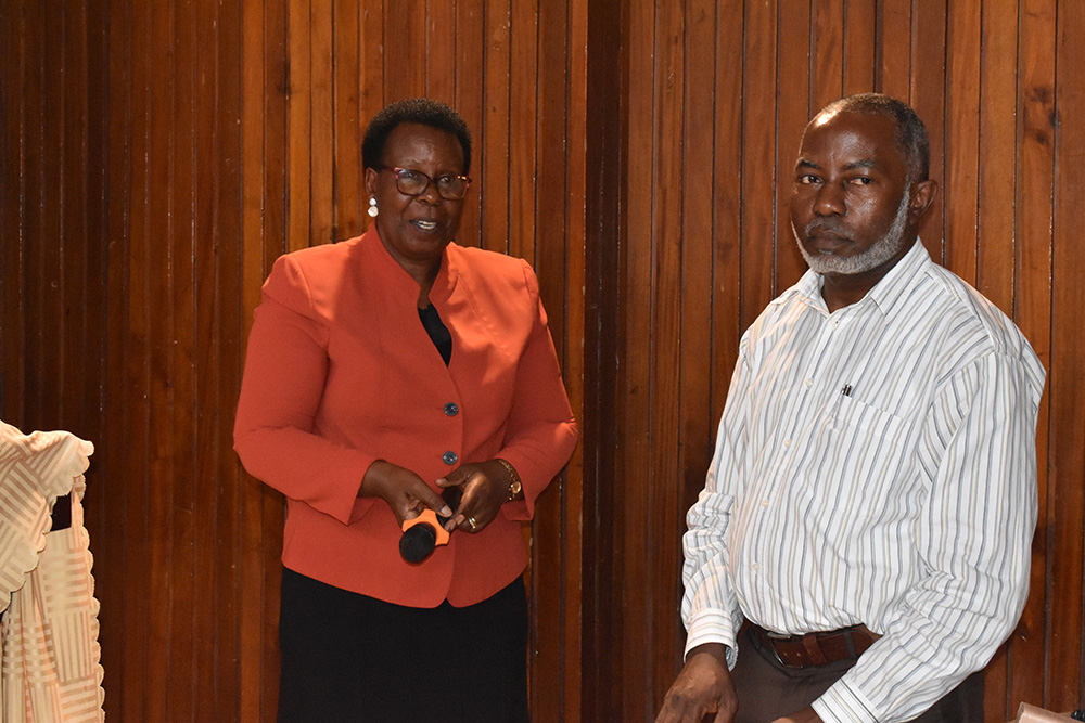 Dr Loy Muhwezi and Gordon Mukasa, officials from the Ministry of Education and Sports, participating in the Education Symposium. (Courtesy photo)