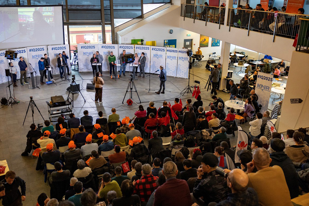An audience member (R) asks a question to the Prime Minister of Greenland and other candidates during a televised all party political debate at the high school, in the capital Nuuk. AFP Photo