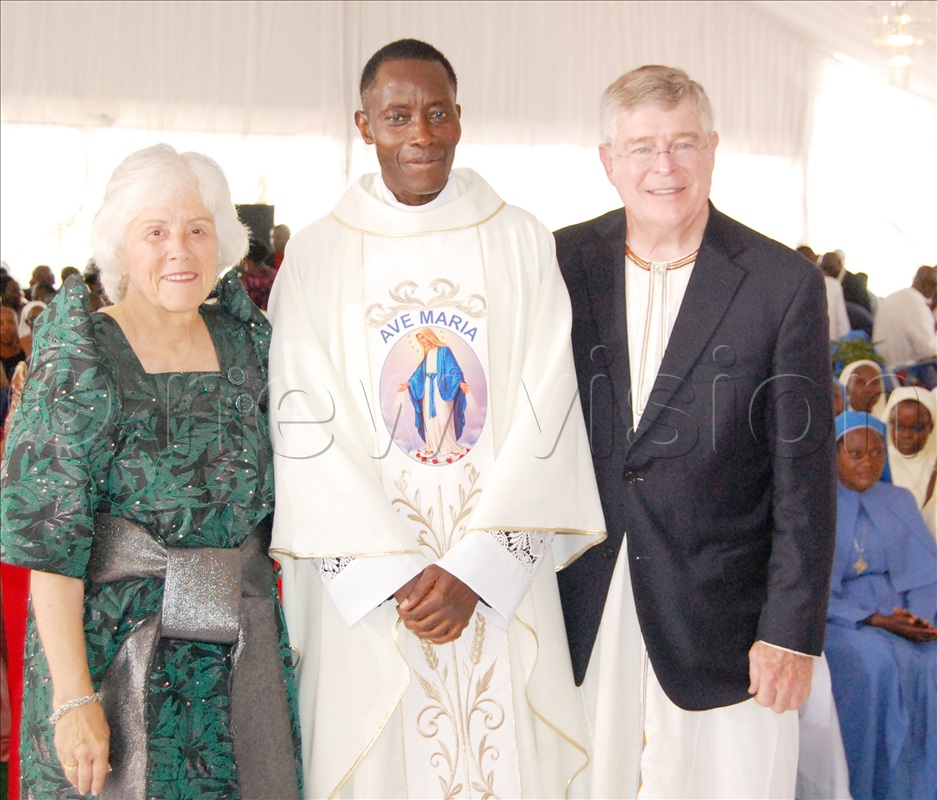 Fr. Emmanuel Tamale (centre) shares a photo moment with his foster parents from the US.