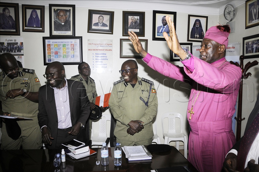 Stephen Kazimba (right), Archbishop of the Church of Uganda, wishing Uganda a peaceful election after a meeting. (Photo by Wilfred Sanya) 