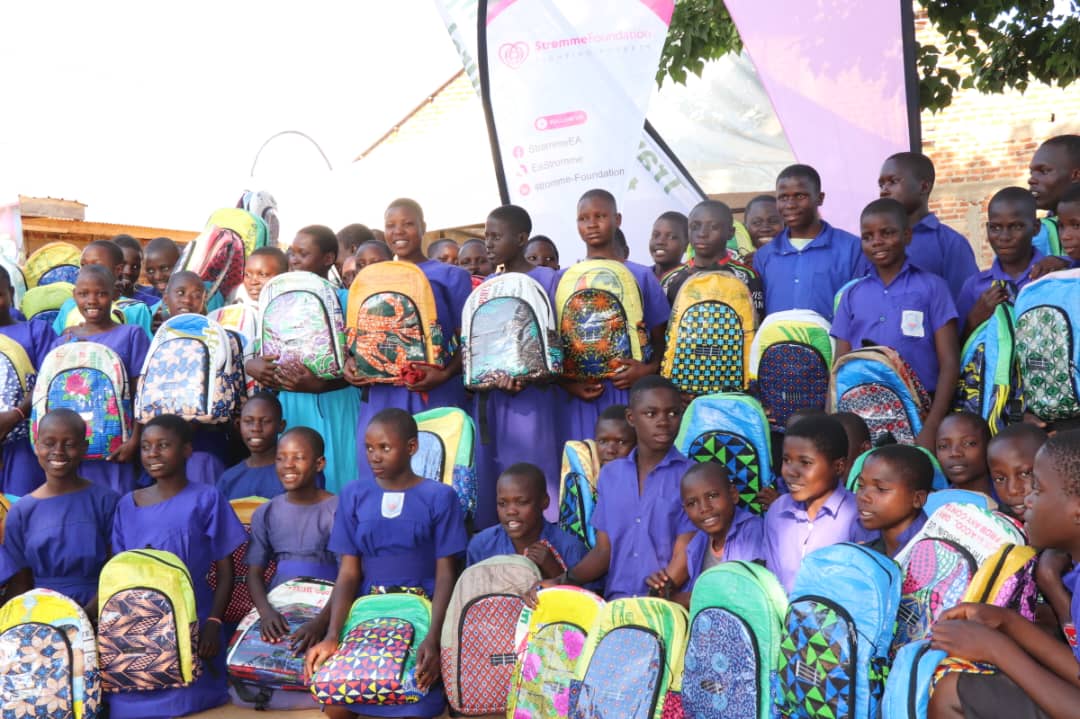 Learners from Walibo Primary School and Namakakale Primary School display their ECOJUA solar-powered bags, launched by Stromme Foundation to promote school retention and completion among children in Luuka District.